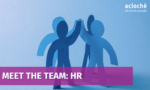 Blue paper-cutout figures high-fiving with a purple banner reading 'MEET THE TEAM: HR' and the 'acloché we know people' logo in the corner.